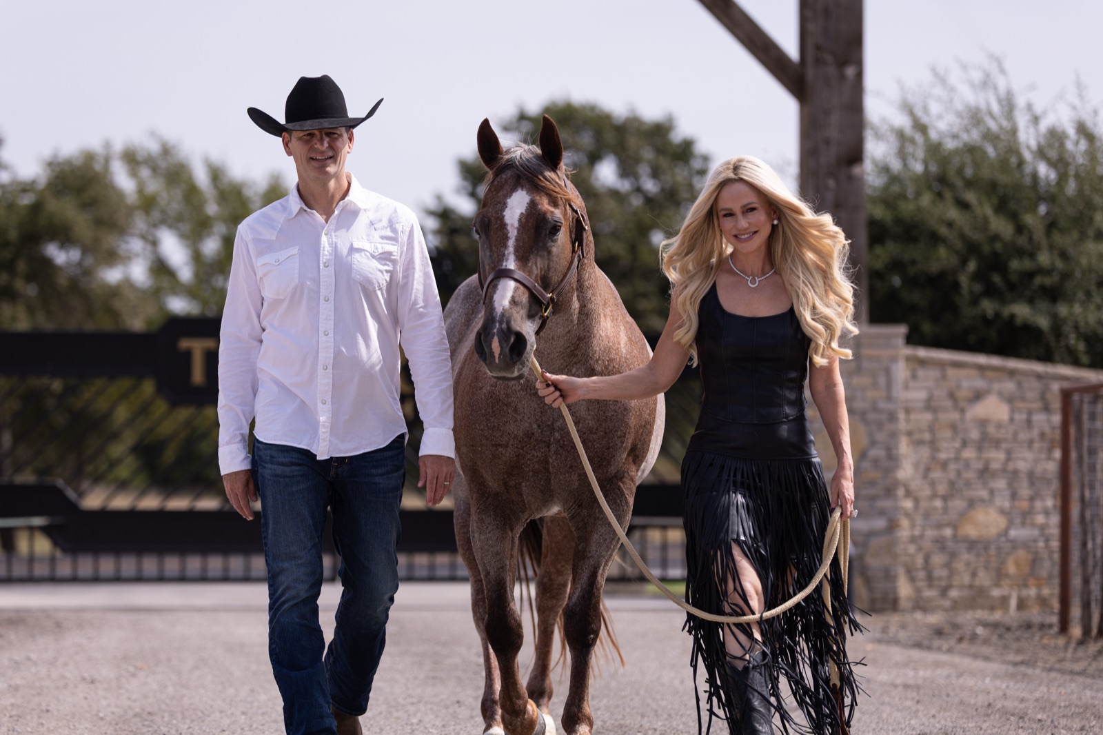 Kisha and Jason Itkin walking Stevie Rey Von through the Theorem Ranch gates
